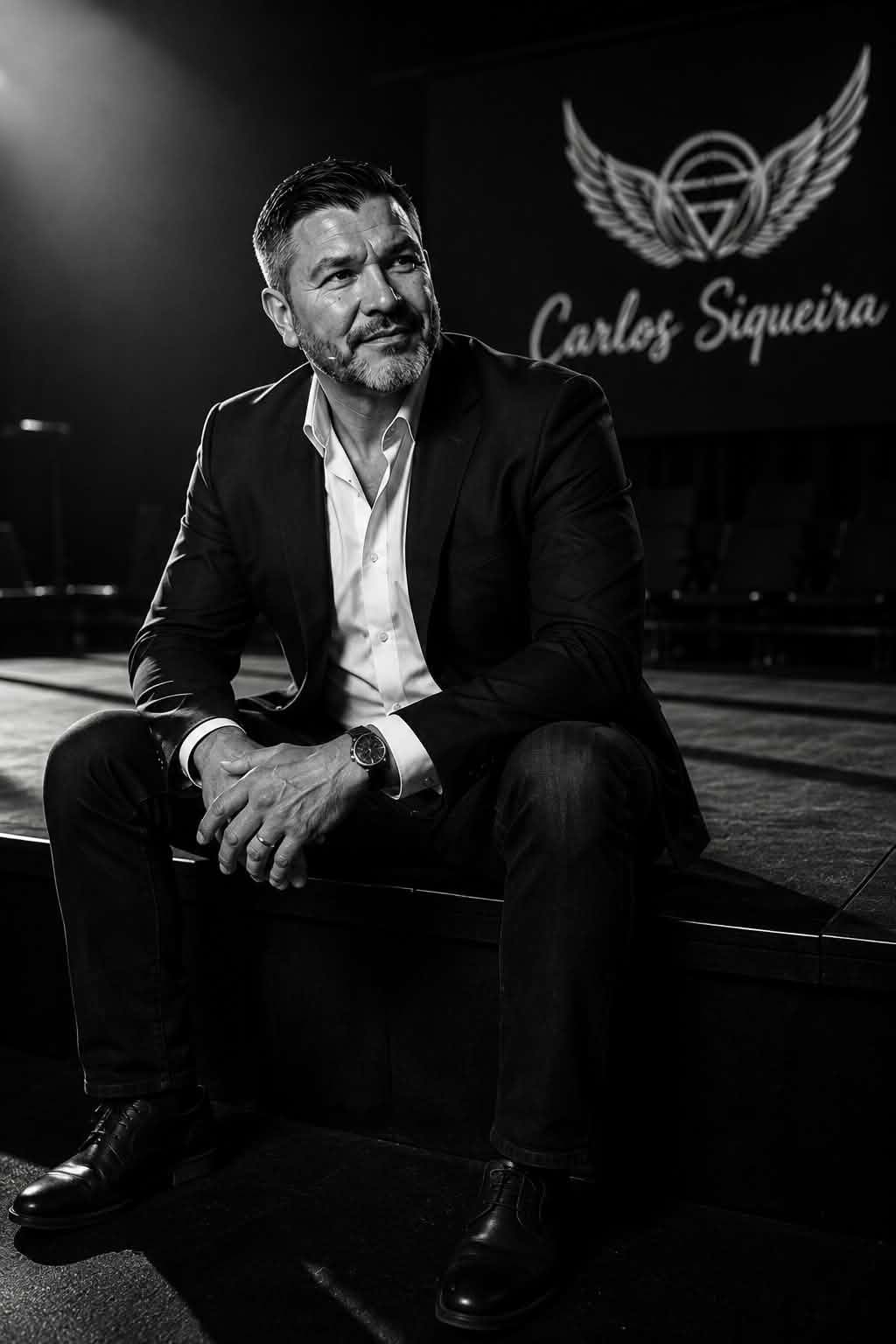 Carlos Siqueira seated on stage